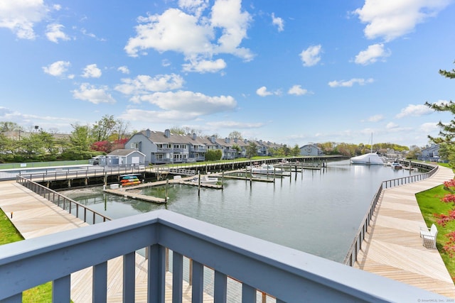 view of water feature with a dock and a residential view