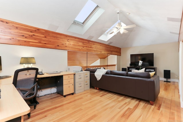office area with light wood-style floors, high vaulted ceiling, a skylight, and ceiling fan