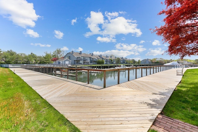 dock area with a residential view and a water view