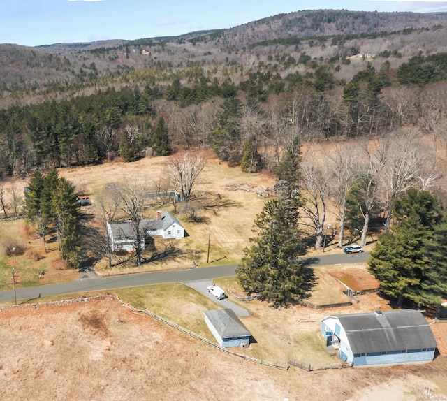 bird's eye view featuring a forest view and a mountain view