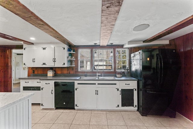 kitchen with light tile patterned flooring, white cabinetry, a sink, and black appliances