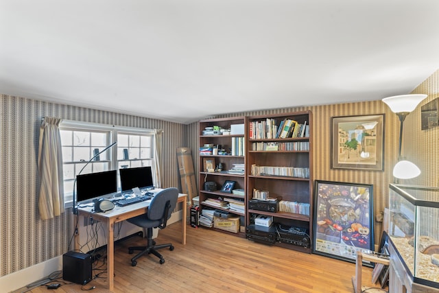 home office featuring hardwood / wood-style floors and wallpapered walls
