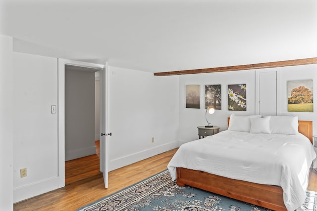 bedroom featuring light wood-style flooring and baseboards