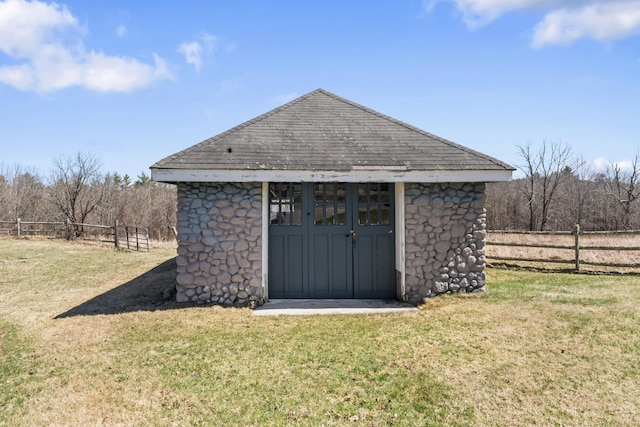 view of shed featuring fence