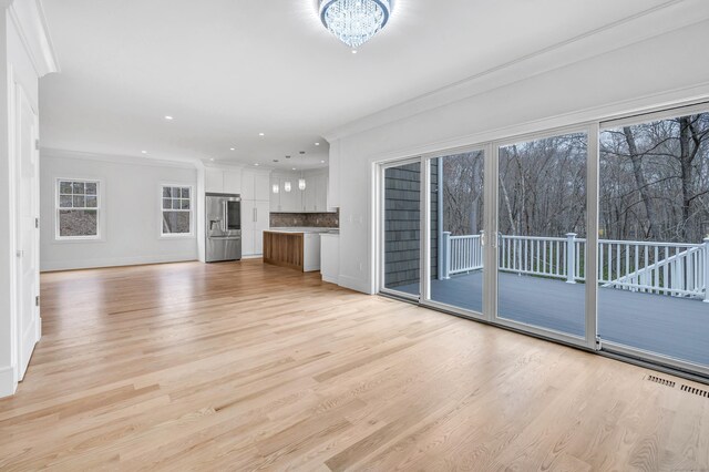 8 Fox Run, Monroe, CT 06468 - unfurnished living room featuring light wood finished floors, ornamental molding, a chandelier, baseboards, and recessed lighting