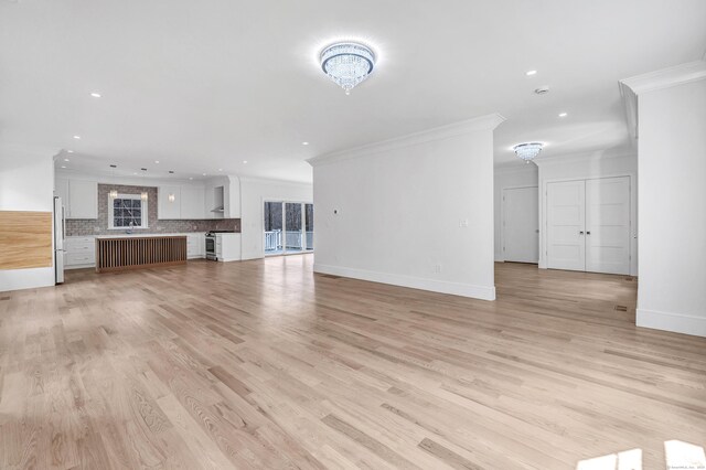 8 Fox Run, Monroe, CT 06468 - unfurnished living room featuring crown molding, recessed lighting, light wood-type flooring, baseboards, and a chandelier