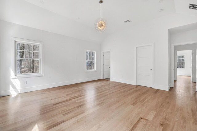 8 Fox Run, Monroe, CT 06468 - unfurnished living room featuring vaulted ceiling, healthy amount of natural light, a chandelier, and light wood-type flooring