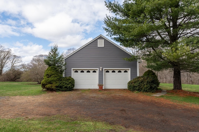 garage with dirt driveway