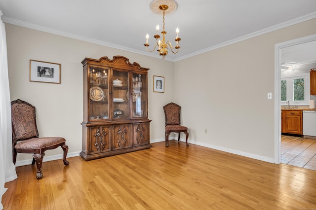 living area featuring light wood finished floors, an inviting chandelier, and ornamental molding