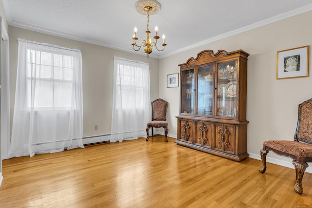 sitting room featuring light wood-type flooring, a chandelier, and crown molding