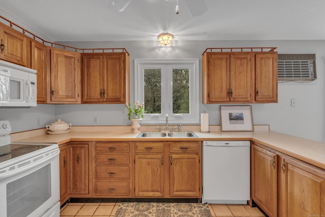 kitchen featuring light countertops, light tile patterned floors, a sink, and white appliances