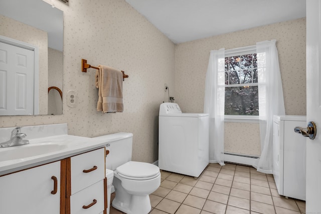 bathroom featuring wallpapered walls, baseboard heating, and washer / clothes dryer