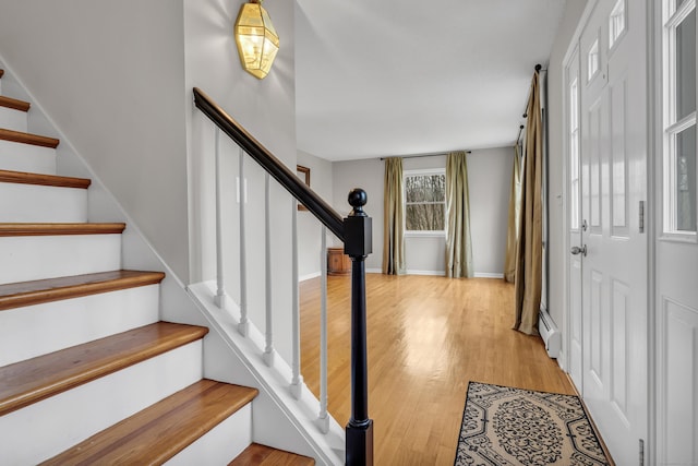 interior space with wood finished floors and baseboard heating