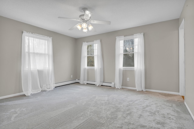 carpeted spare room featuring baseboards and ceiling fan