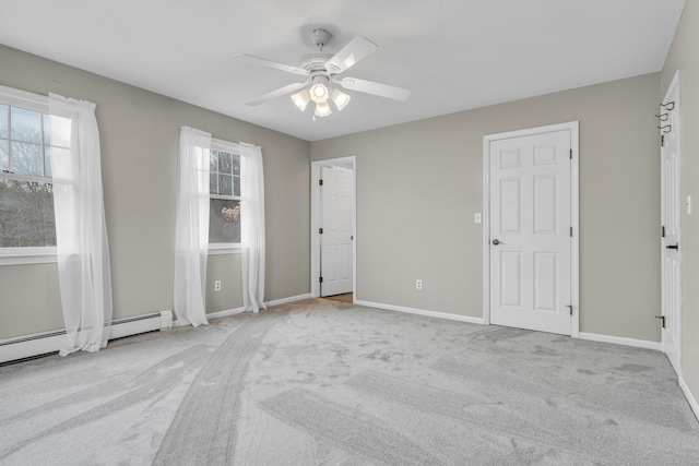 carpeted empty room with a ceiling fan, baseboards, and a baseboard radiator