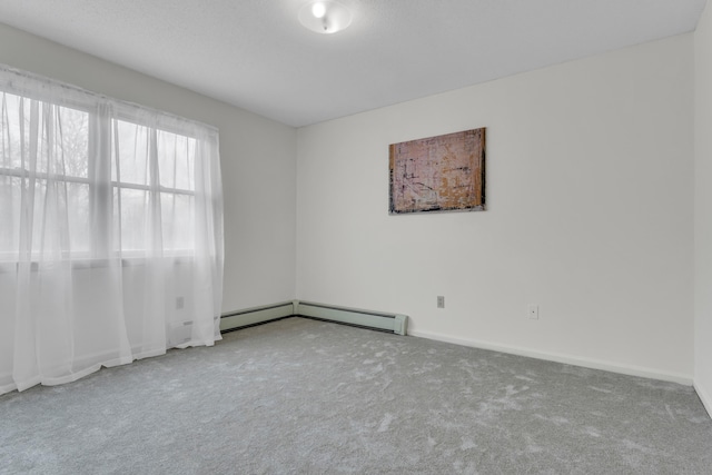 carpeted empty room featuring baseboards