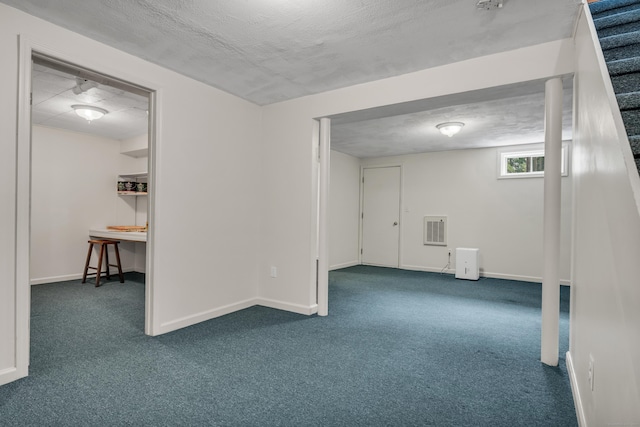 carpeted empty room with baseboards and visible vents