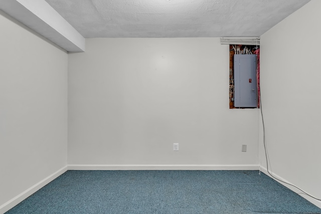 empty room with baseboards, a textured ceiling, electric panel, and carpet