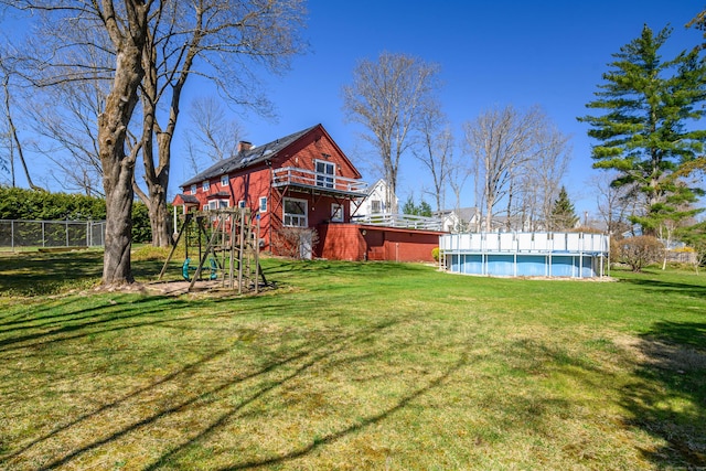 view of yard with a fenced in pool and fence