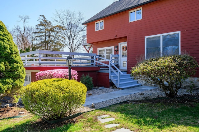 back of property featuring a wooden deck