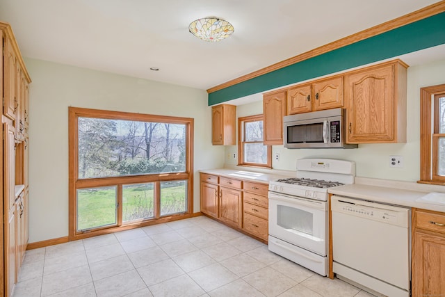 kitchen with light countertops, white appliances, and light tile patterned floors