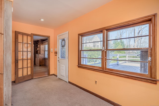 foyer featuring recessed lighting, light carpet, and baseboards