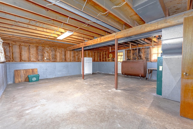below grade area with freestanding refrigerator and heating fuel