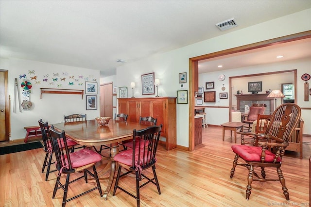dining area featuring light wood-type flooring, baseboards, and recessed lighting
