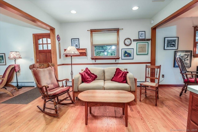 sitting room featuring light wood-style flooring, a baseboard radiator, baseboards, and recessed lighting