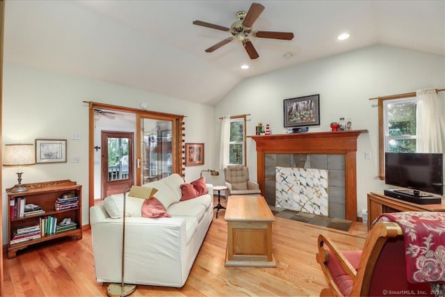 living room featuring ceiling fan, lofted ceiling, healthy amount of natural light, light wood finished floors, and recessed lighting