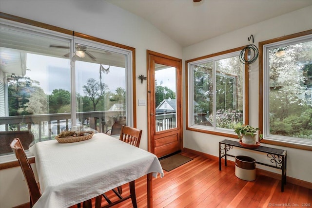 sunroom featuring plenty of natural light, baseboards, lofted ceiling, and hardwood / wood-style floors