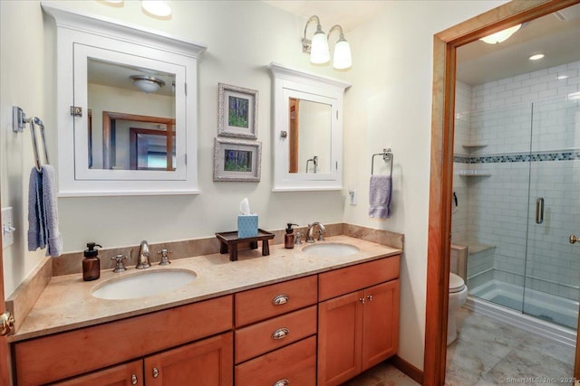 full bath featuring a shower stall, toilet, and double vanity