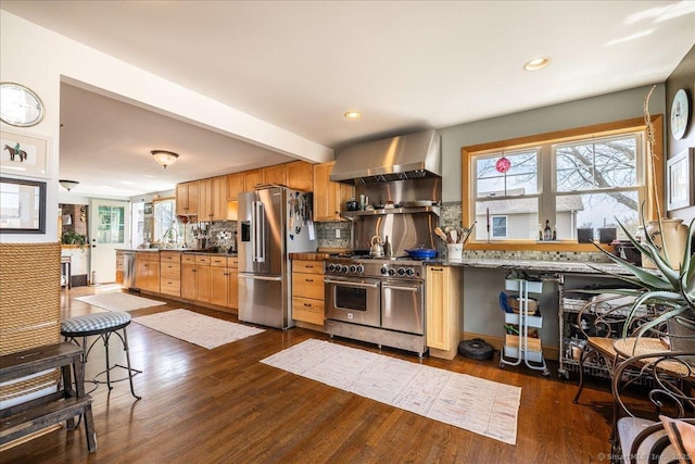 38 Elaine Rd, Milford, CT 06460 - kitchen featuring high quality appliances, wall chimney range hood, decorative backsplash, dark wood-type flooring, and plenty of natural light