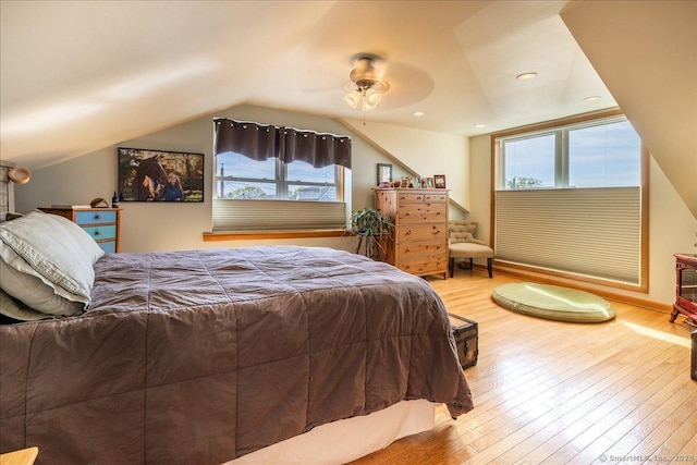 bedroom with hardwood / wood-style floors and multiple windows