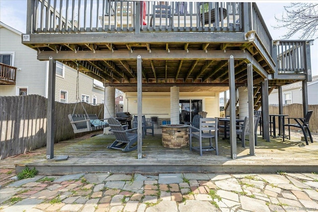 view of patio featuring a deck, an outdoor fire pit, fence, and grilling area