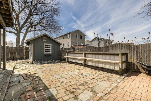 view of patio / terrace with an outdoor structure and a fenced backyard