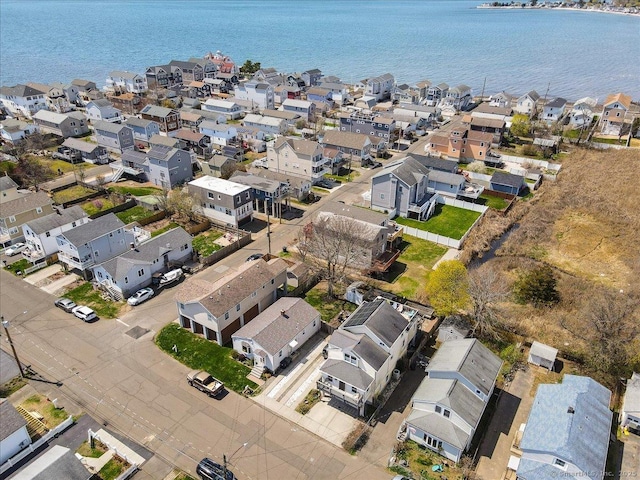 drone / aerial view with a residential view and a water view