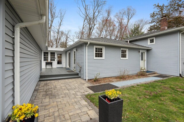 42 Stonecrop Rd, Norwalk, CT 06851 - rear view of property with a wooden deck, a chimney, and a patio