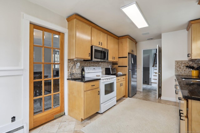 42 Stonecrop Rd, Norwalk, CT 06851 - kitchen with white electric range, stainless steel microwave, backsplash, visible vents, and freestanding refrigerator