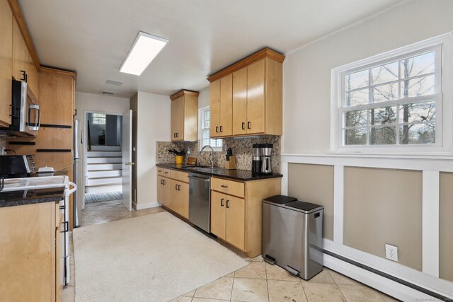 42 Stonecrop Rd, Norwalk, CT 06851 - kitchen with baseboard heating, a sink, decorative backsplash, light tile patterned flooring, and stainless steel appliances