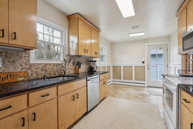 42 Stonecrop Rd, Norwalk, CT 06851 - kitchen with a sink, dark stone countertops, tasteful backsplash, appliances with stainless steel finishes, and a baseboard radiator