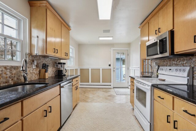 42 Stonecrop Rd, Norwalk, CT 06851 - kitchen featuring plenty of natural light, a sink, dark stone countertops, and appliances with stainless steel finishes