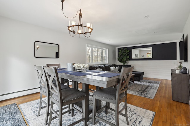 42 Stonecrop Rd, Norwalk, CT 06851 - dining room featuring a baseboard radiator, wood finished floors, and an inviting chandelier