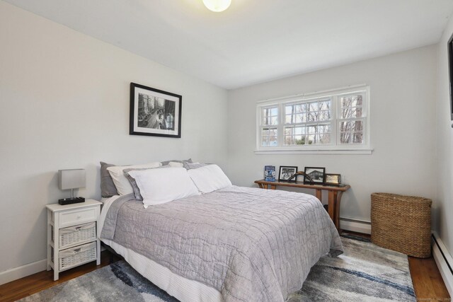 42 Stonecrop Rd, Norwalk, CT 06851 - bedroom with a baseboard heating unit, baseboards, and wood finished floors
