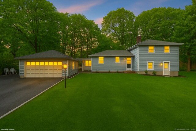 42 Stonecrop Rd, Norwalk, CT 06851 - tri-level home with a front lawn, a detached garage, and a chimney