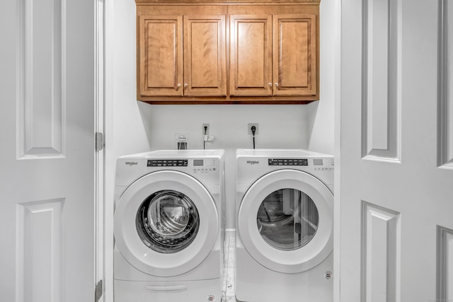 washroom with independent washer and dryer and cabinet space