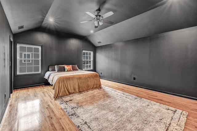 bedroom with wood finished floors, lofted ceiling, and ceiling fan