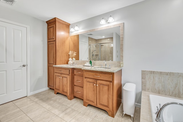 full bath featuring a shower stall, vanity, a tub, and baseboards