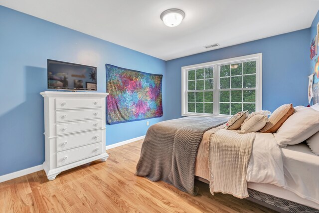 bedroom featuring light wood-type flooring and baseboards