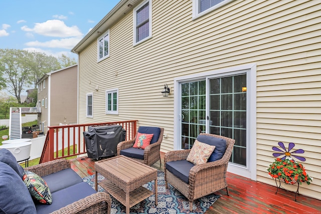 wooden terrace featuring outdoor lounge area and grilling area
